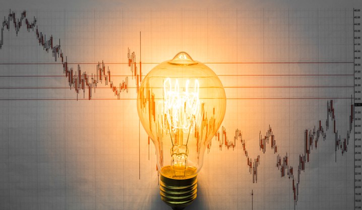 Lit Light Bulb With Graph Background